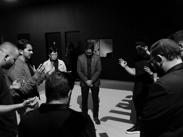 Equipe em oração antes de subir ao palco